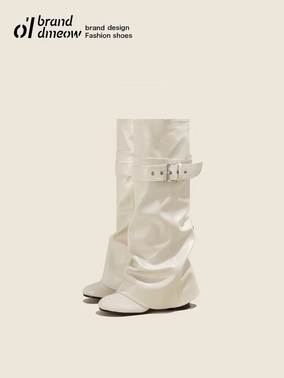White slouchy knee-high boots with a buckle strap on a neutral background.