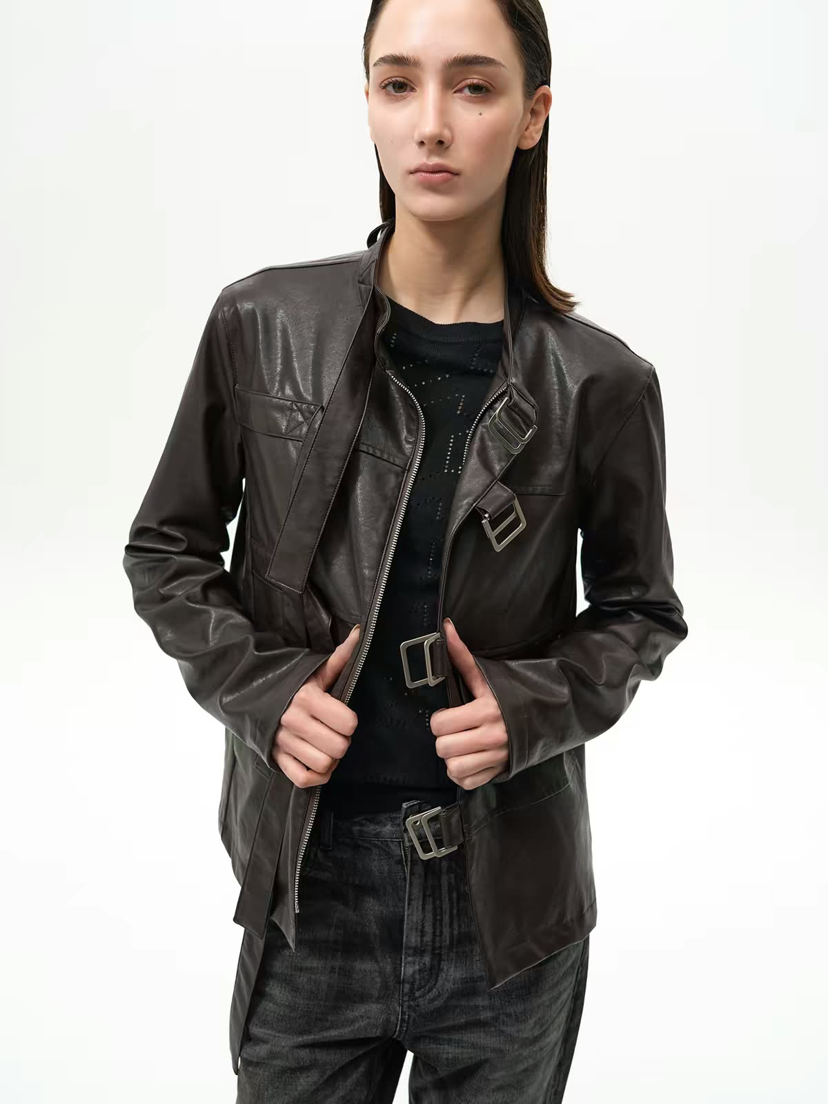 Model wearing a black leather jacket with dark jeans